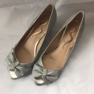 Nina sparkly silver open toe wedge heels with bow